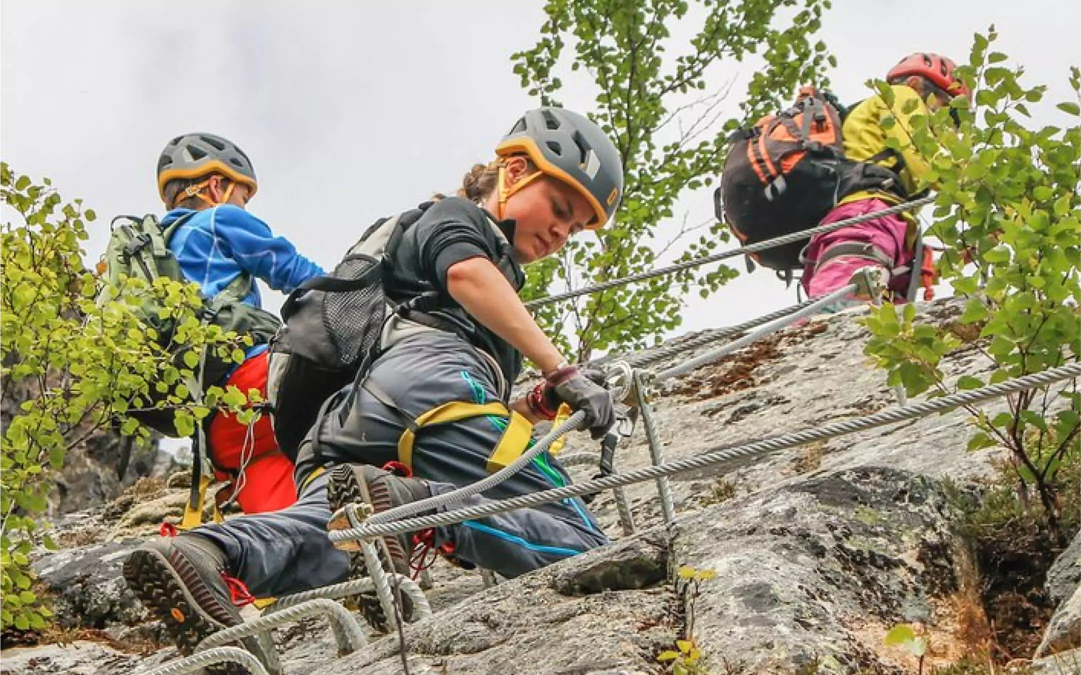 Climbers using harnesses and cables on a Via Ferrata in the Sacred Valley
